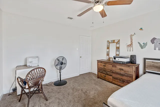 a bedroom with furniture and a window