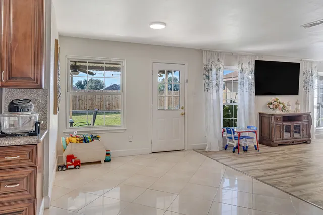 a view of a livingroom with furniture and a flat screen tv