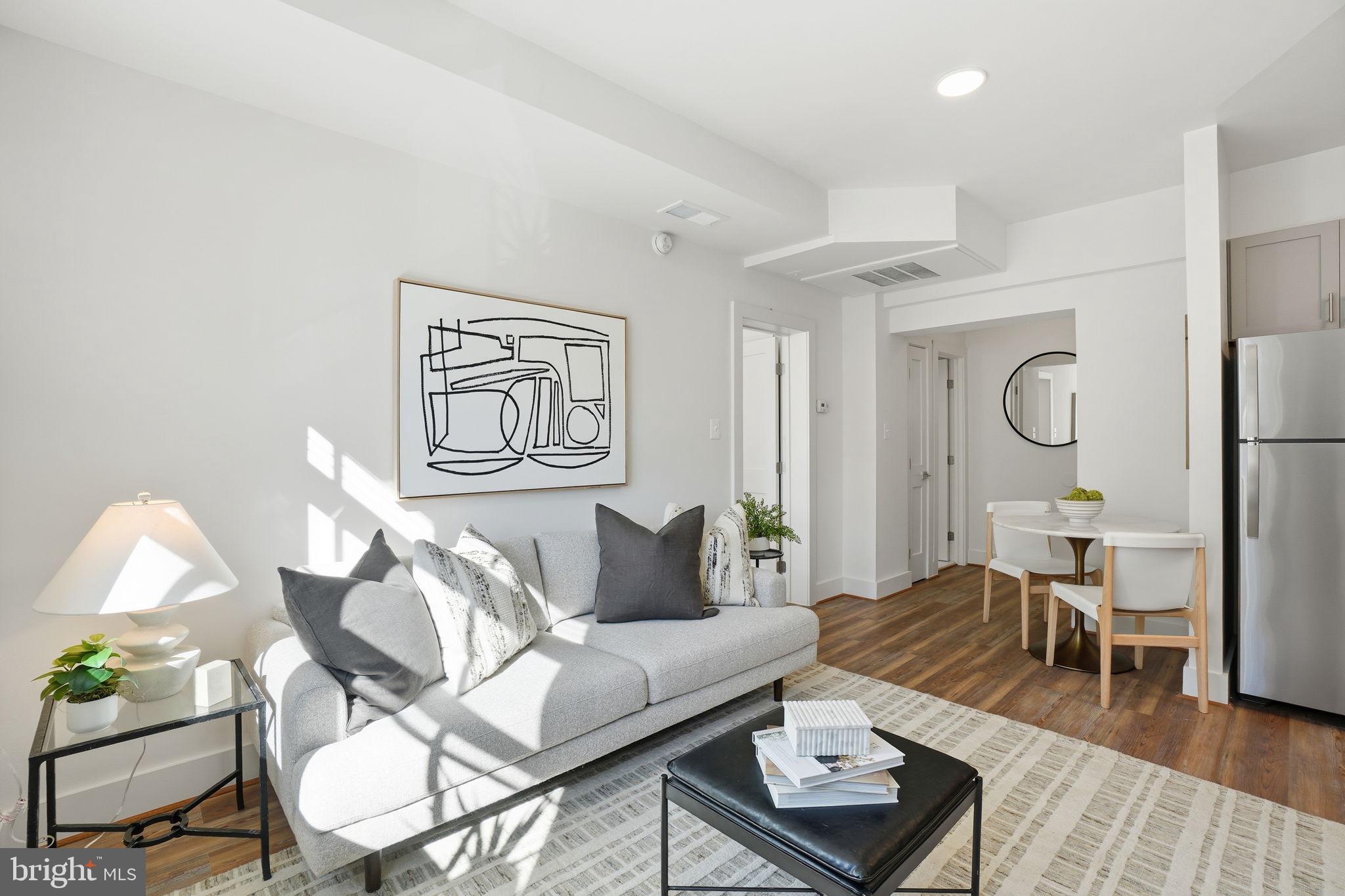 1451 Park Road Northwest, Unit 114 Washington, DC 20010 - Photo 12 of 23 a living room with furniture and a wooden floor