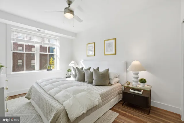 a bedroom with a bed and a window