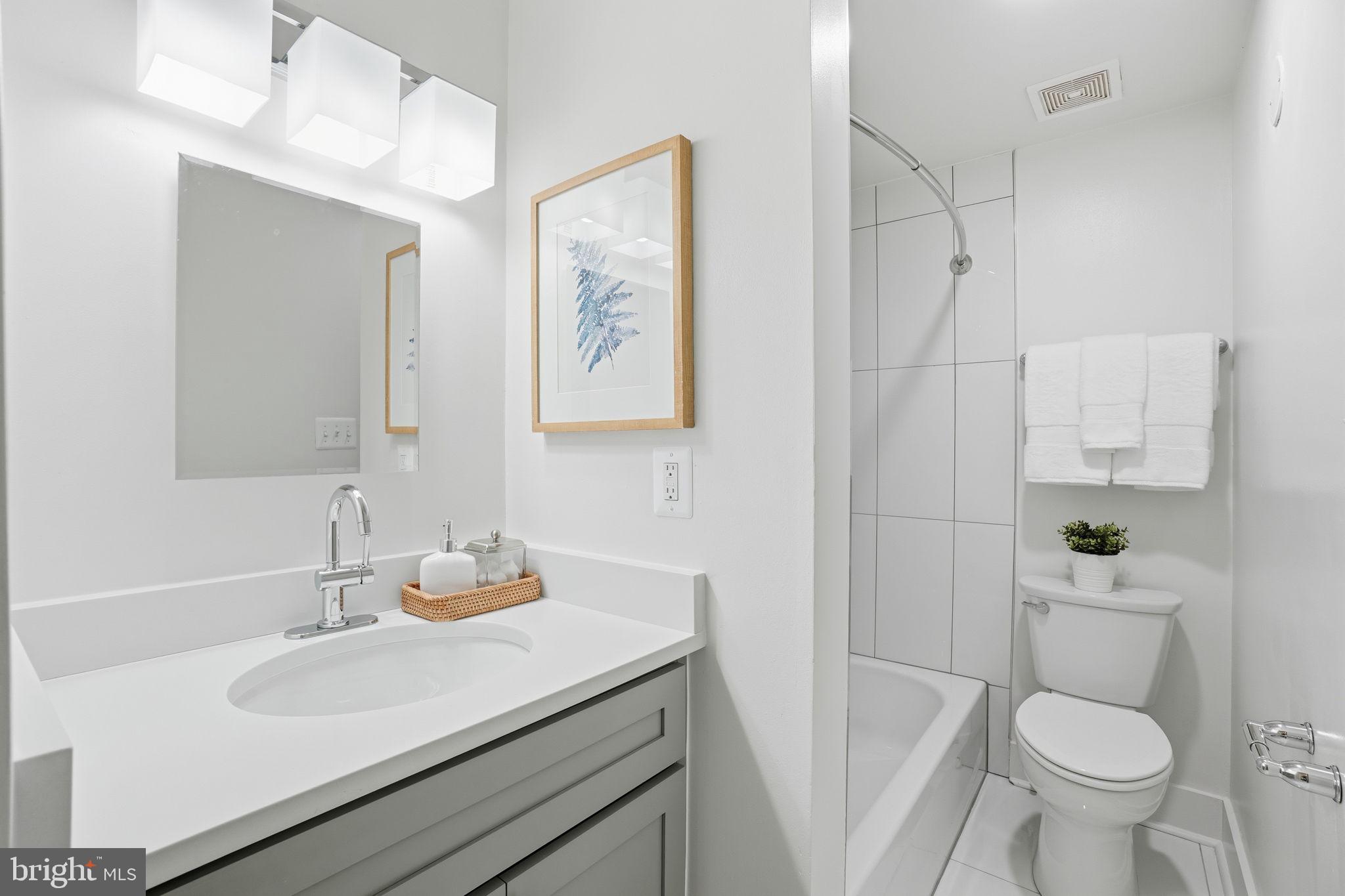 1451 Park Road Northwest, Unit 114 Washington, DC 20010 - Photo 19 of 23 a bathroom with a sink toilet and shower