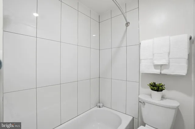 a bathroom with a toilet and shower