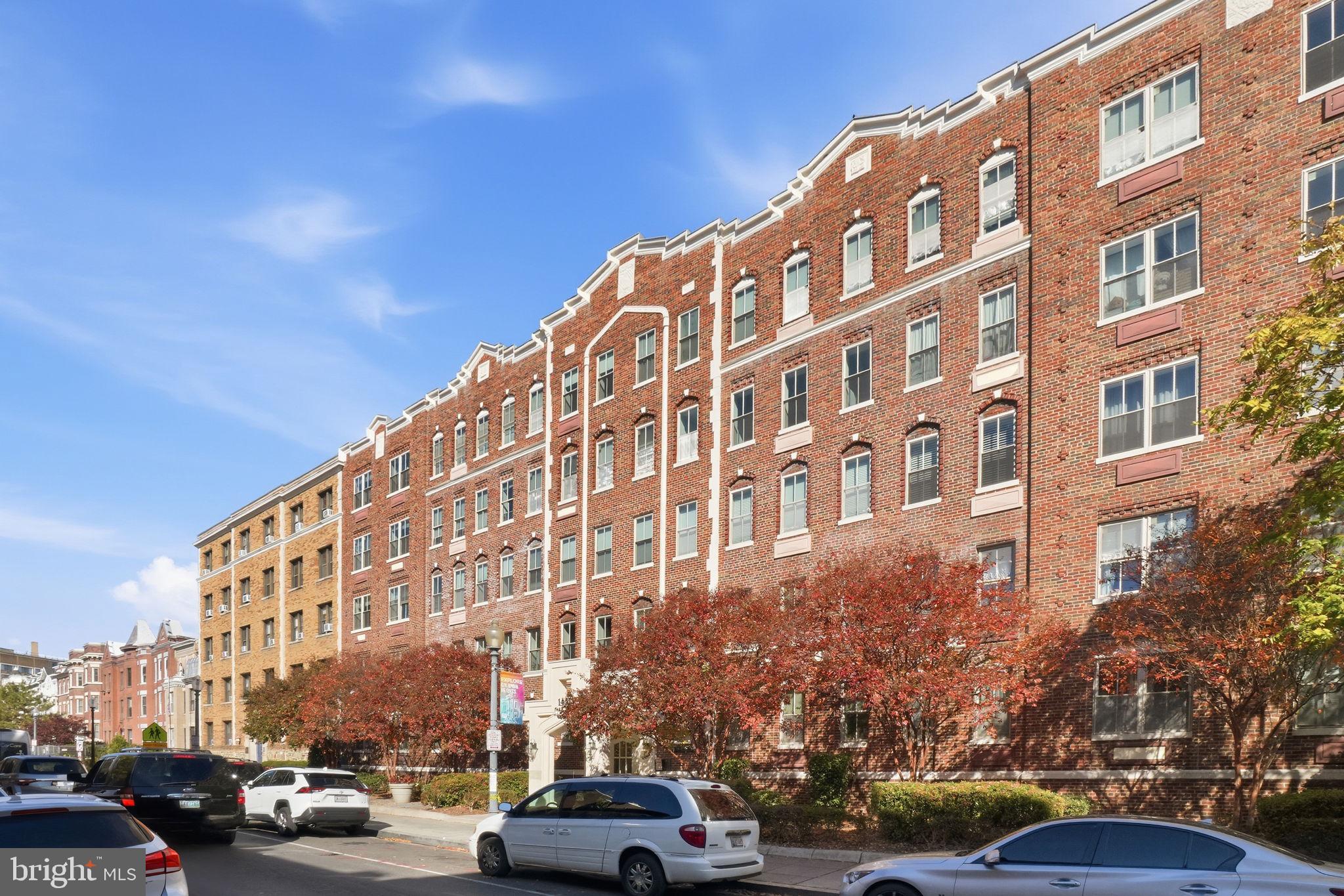 1451 Park Road Northwest, Unit 114 Washington, DC 20010 - Photo 2 of 23 a view of a building and car parked on the roadside
