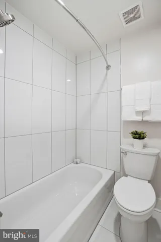 a bathroom with a toilet and bathtub