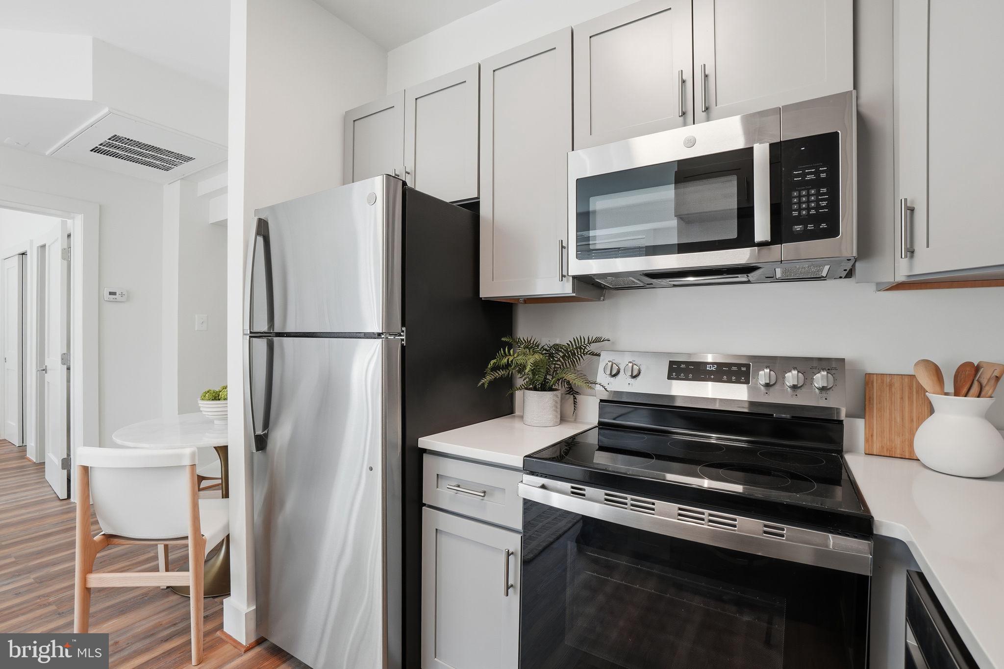 1451 Park Road Northwest, Unit 114 Washington, DC 20010 - Photo 8 of 23 a kitchen with a refrigerator stove and microwave