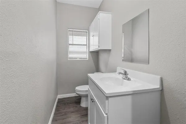 a bathroom with a sink toilet and vanity