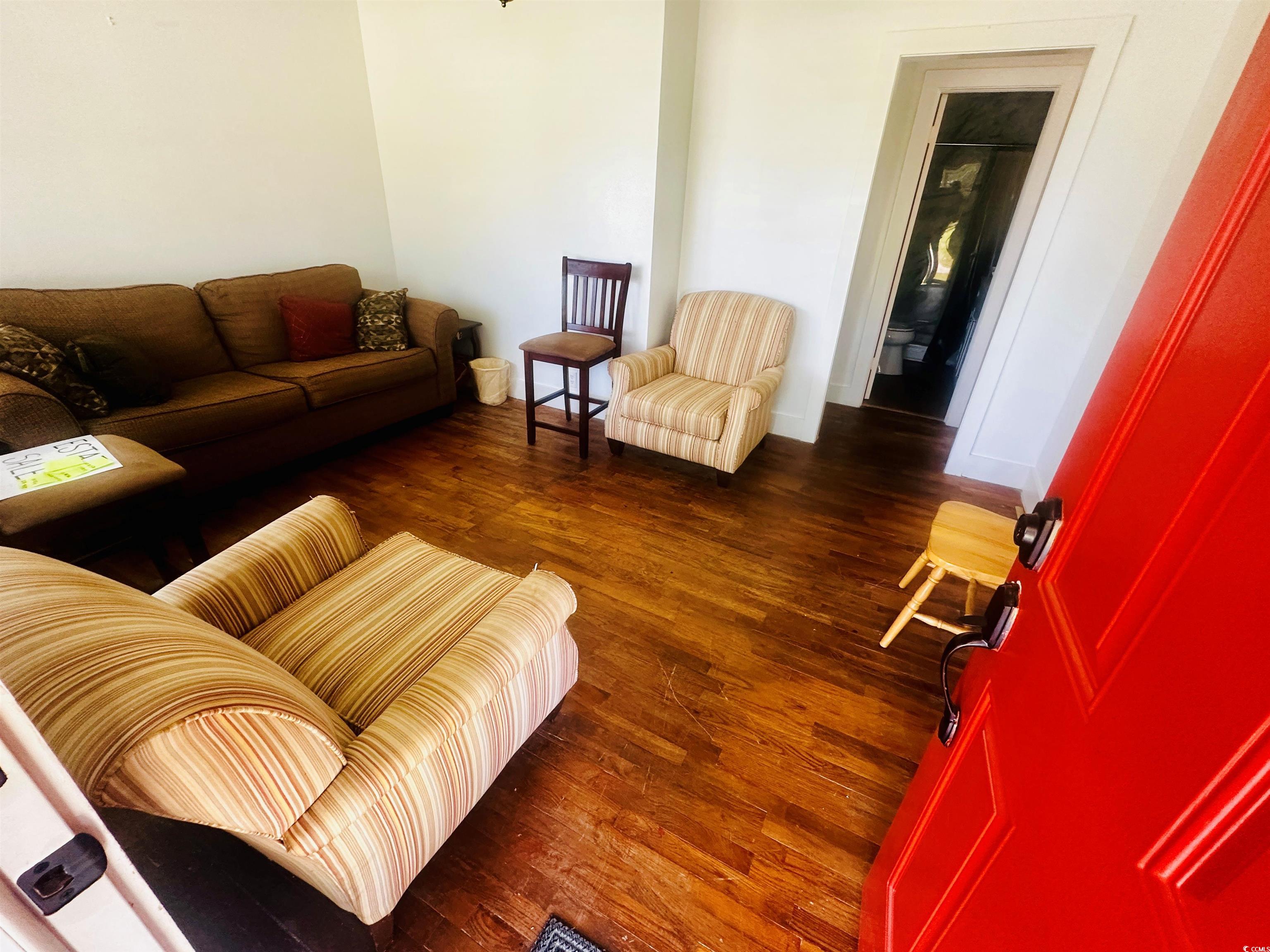 8 Raymond Street Andrews, SC 29510 - Photo 2 of 13 Living area featuring dark wood finished floors