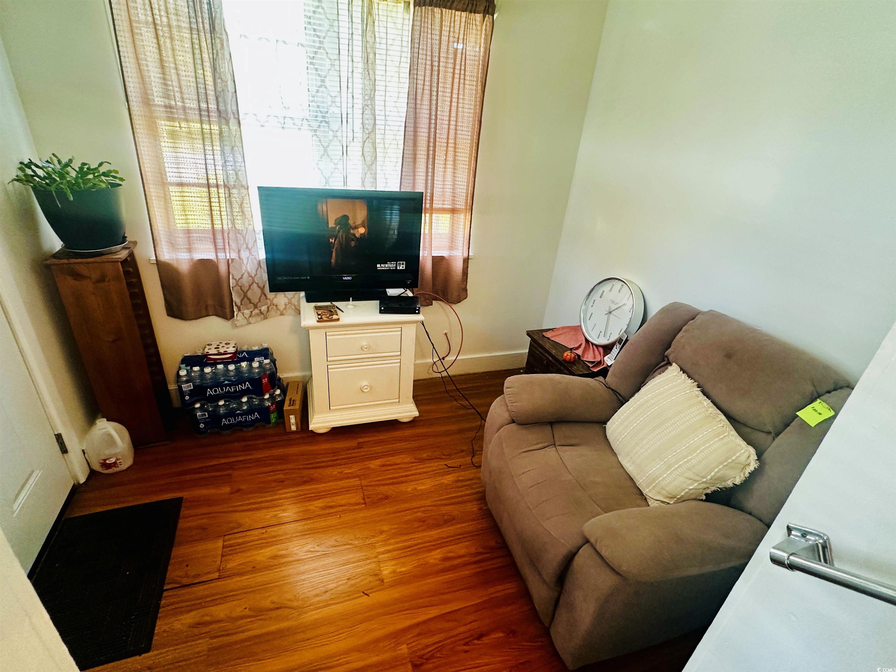 8 Raymond Street Andrews, SC 29510 - Photo 3 of 13 Living room with dark wood finished floors and baseboards