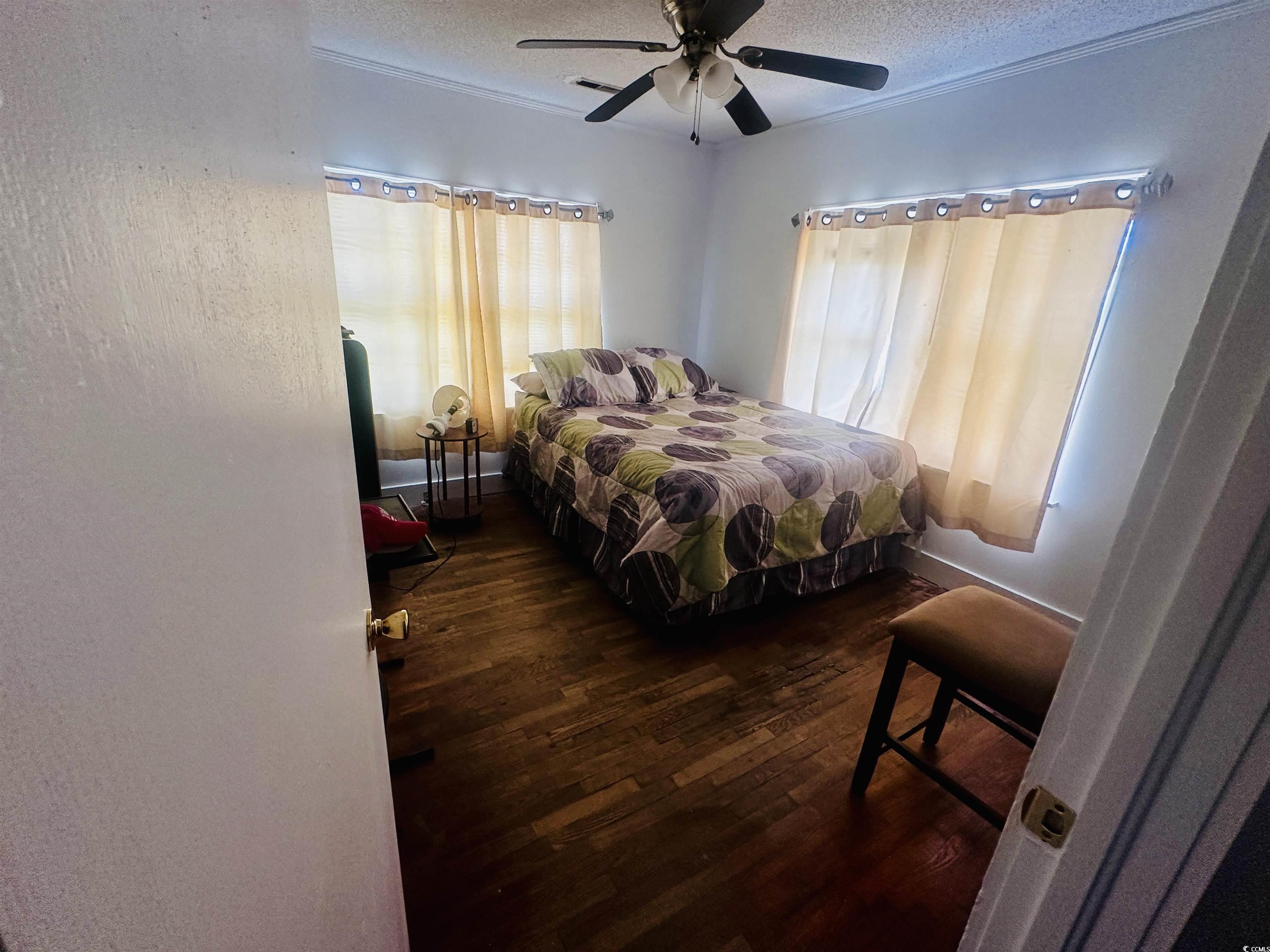 8 Raymond Street Andrews, SC 29510 - Photo 5 of 13 Bedroom with dark wood-type flooring, a textured ceiling, and ceiling fan