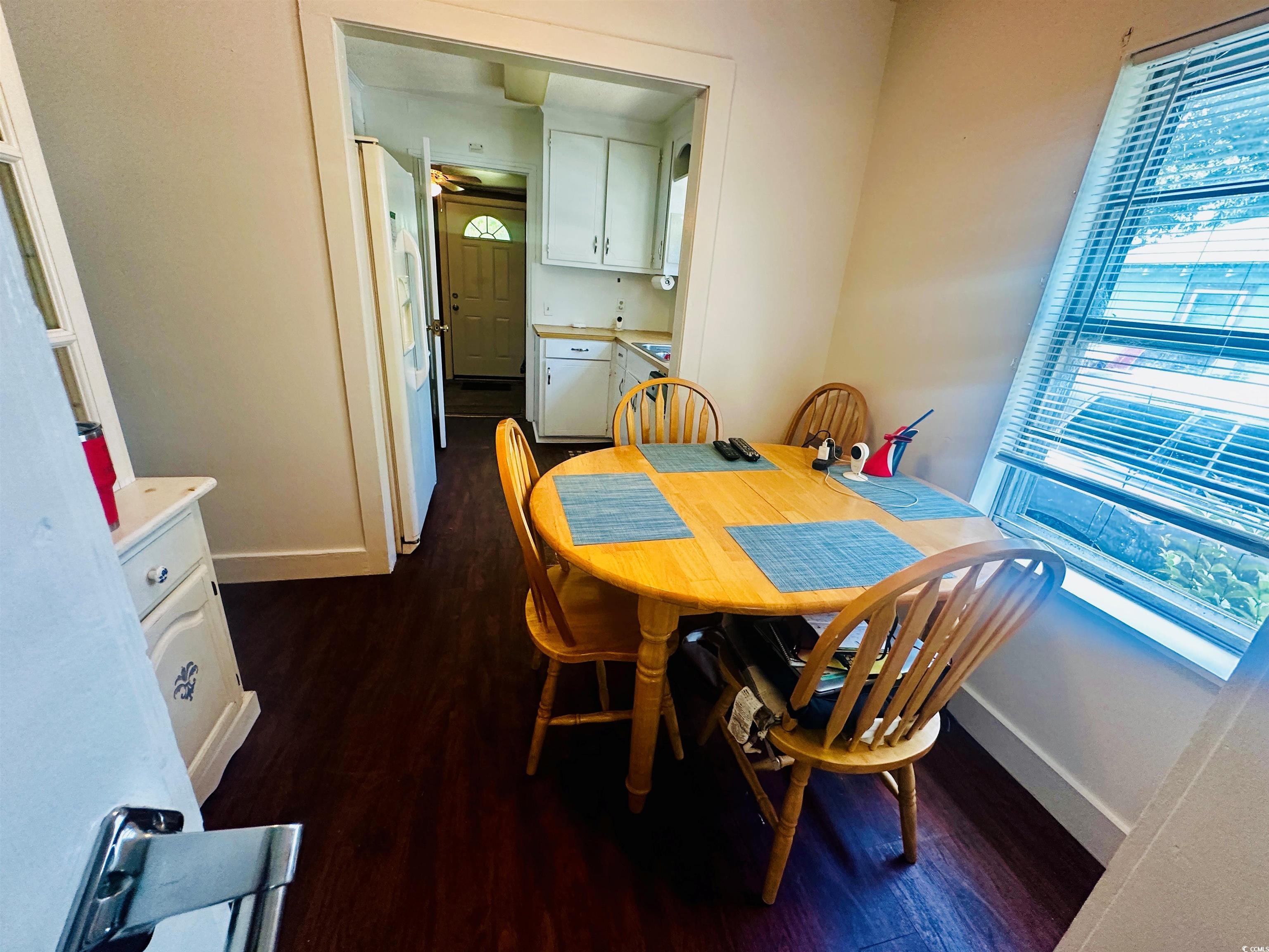 8 Raymond Street Andrews, SC 29510 - Photo 7 of 13 Dining room featuring dark wood-style floors and plenty of natural light