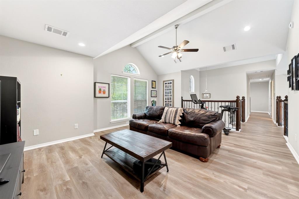 4509 Scenic Drive Rowlett, TX 75088 - Photo 32 of 40 Spacious living area featuring a vaulted ceiling with exposed beams, wood-finish flooring, recessed lighting, and a ceiling fan