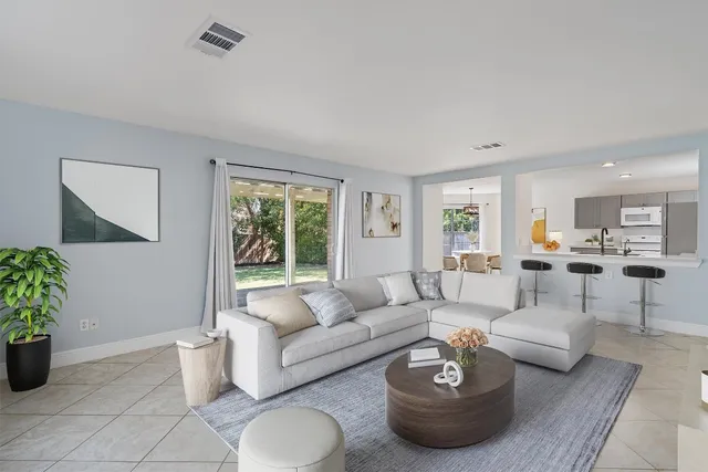 a living room with furniture and a potted plant