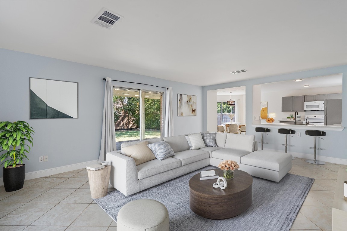 a living room with furniture and a potted plant