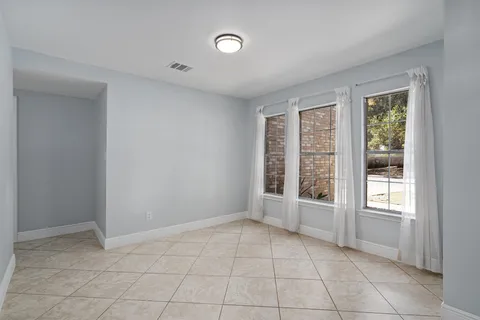 a view of an empty room with windows