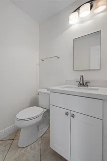 an empty room with a ceiling fan and glass door