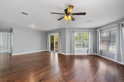 wooden floor in an empty room with a window