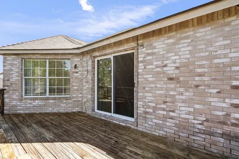 a view of balcony with wooden floor and fence