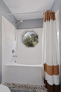 a bathroom with a sink toilet and window