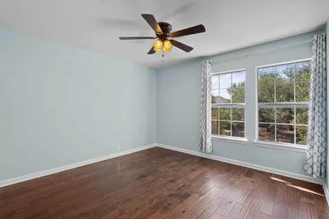 a view of an empty room and wooden floor