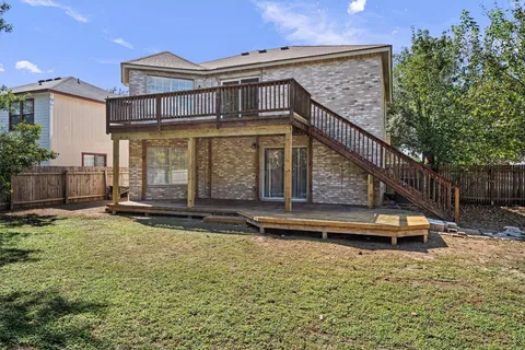 a backyard of a house with table and chairs