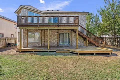 a view of a house with backyard and sitting area