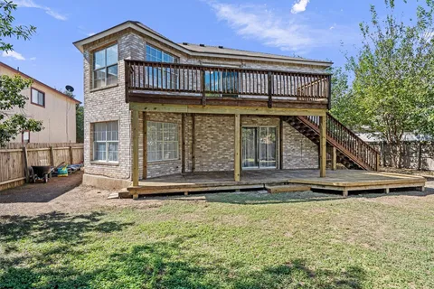 a view of a house with a large window and wooden floor