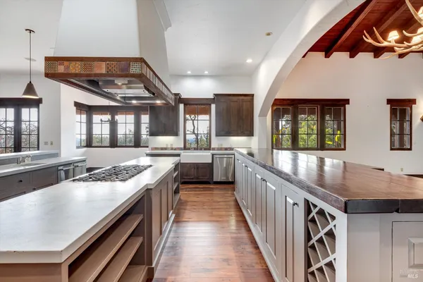a kitchen with granite countertop a sink stove and cabinets