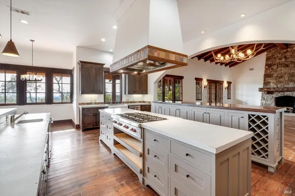 a kitchen with stainless steel appliances a stove a refrigerator and cabinets