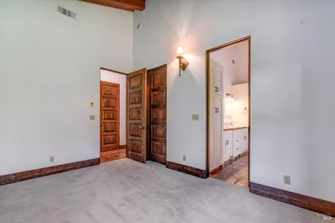 a view of an empty room with a bathroom