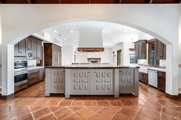 a kitchen with a stove and a white cabinets