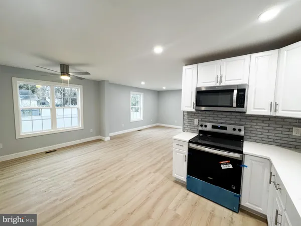 a kitchen with stainless steel appliances a stove sink and microwave