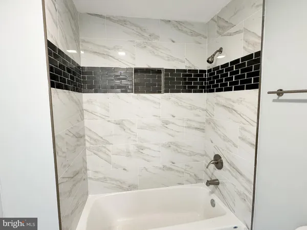 a bathroom with a bathtub and shower