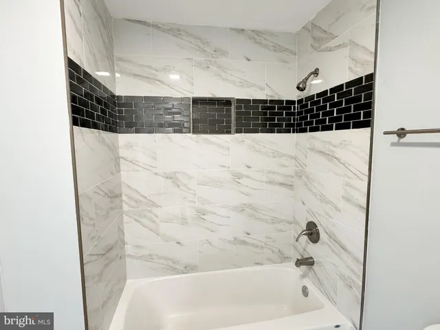 a bathroom with a bathtub and shower