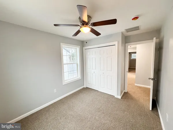 a view of empty room with ceiling fan