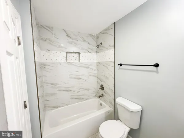 a bathroom with a toilet and a bathtub