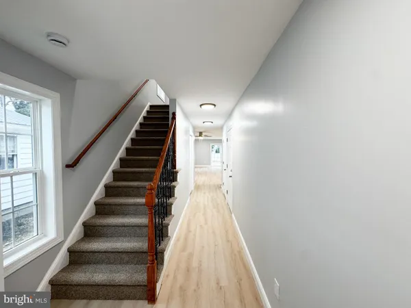 a view of entryway and hall with wooden floor