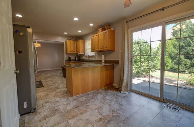 a kitchen with stainless steel appliances granite countertop a refrigerator and a stove