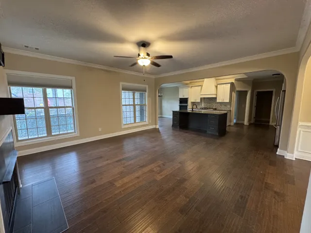 a view of a livingroom with furniture wooden floor and chandelier