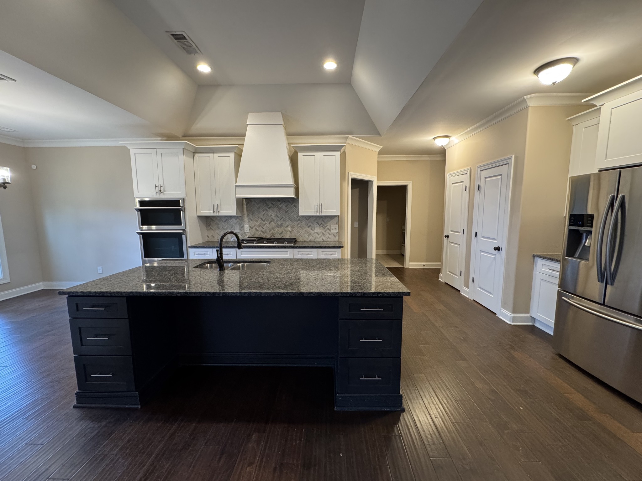 2006 Eagle View Road Hendersonville, TN 37075 - Photo 5 of 28 a kitchen with stainless steel appliances kitchen island granite countertop a refrigerator a sink dishwasher a stove and white cabinets with wooden floor