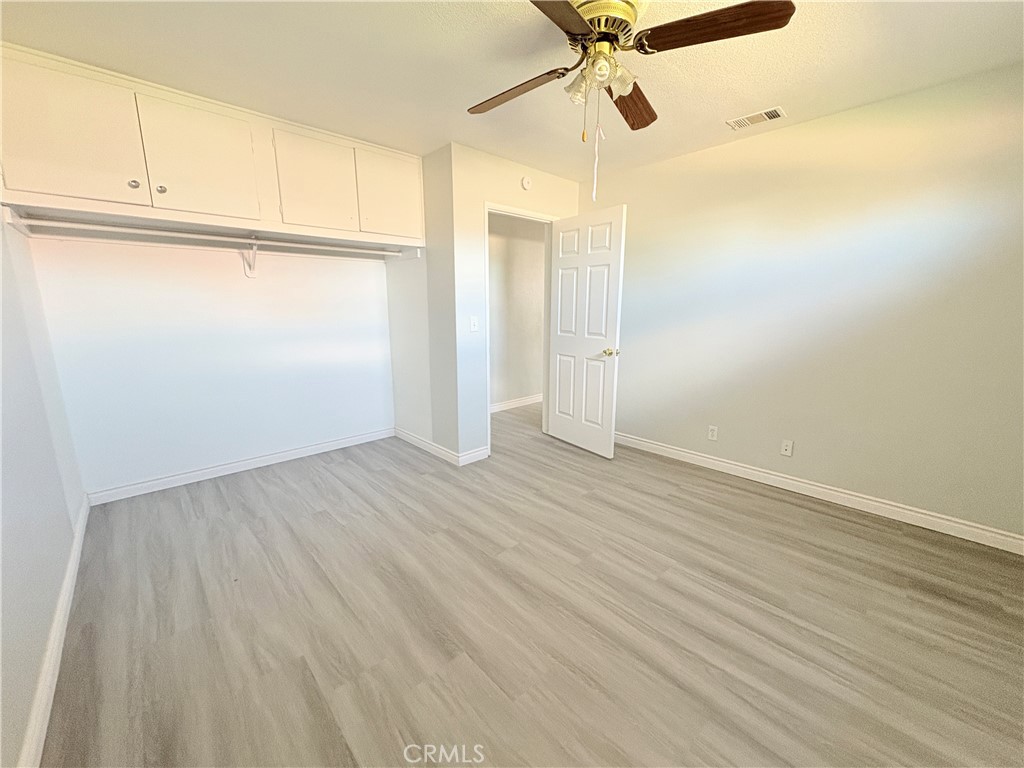 14027 Navajo Road Apple Valley, CA 92307 - Photo 14 of 25 a view of a room with wooden floor