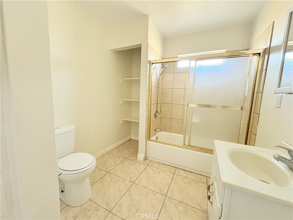 14027 Navajo Road Apple Valley, CA 92307 - Photo 15 of 25 a bathroom with a sink toilet and shower