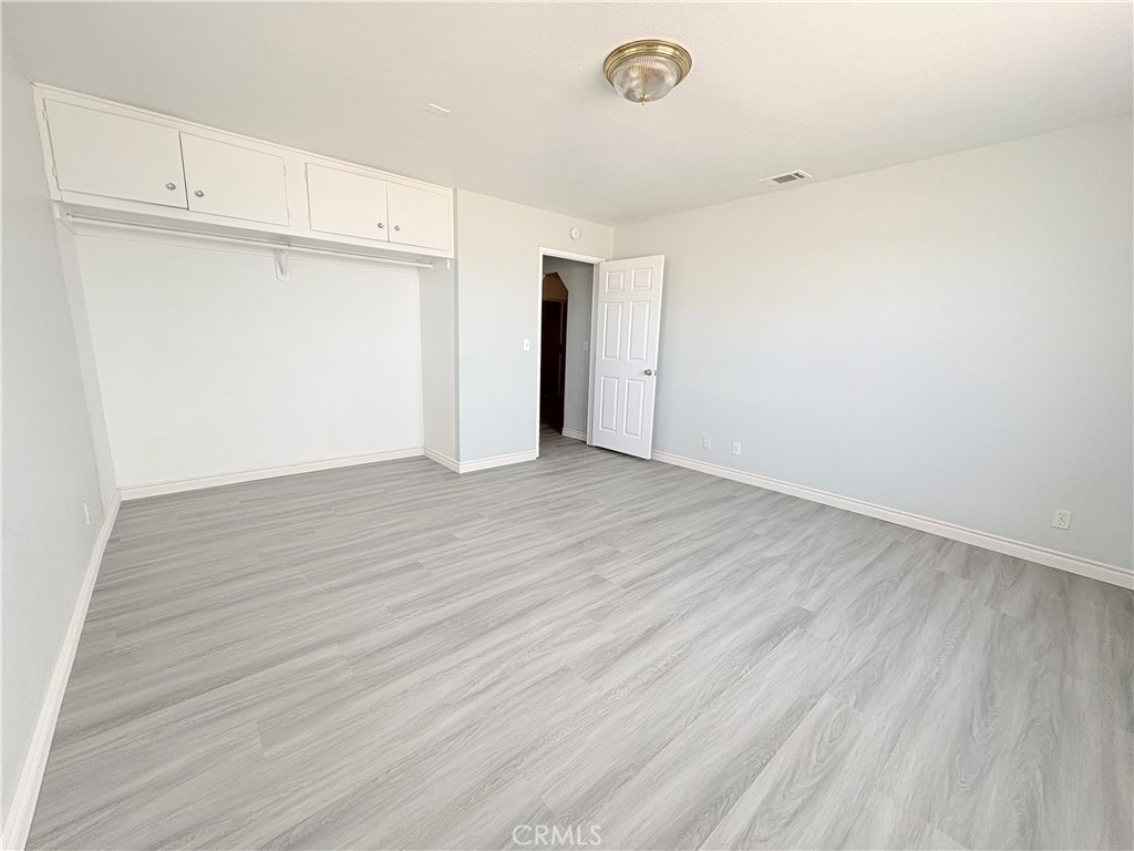 14027 Navajo Road Apple Valley, CA 92307 - Photo 16 of 25 an empty room with wooden floor
