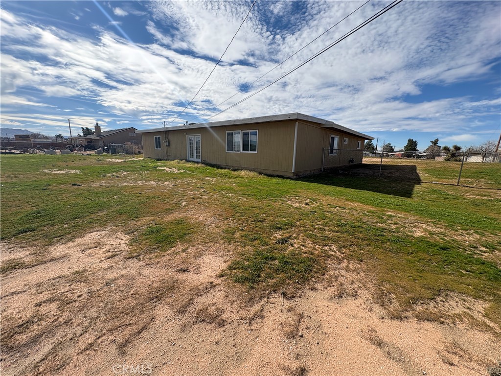 14027 Navajo Road Apple Valley, CA 92307 - Photo 20 of 25 a front view of a house with a yard