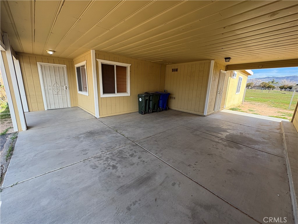 14027 Navajo Road Apple Valley, CA 92307 - Photo 23 of 25 a view of an empty room with a fireplace and a window