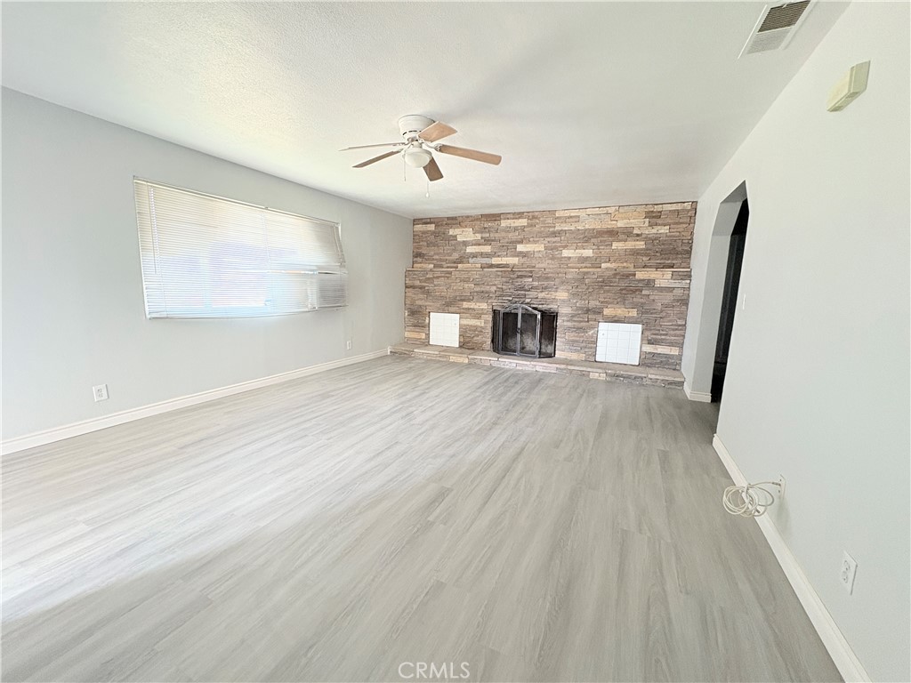14027 Navajo Road Apple Valley, CA 92307 - Photo 3 of 25 wooden floor in an empty room with a window