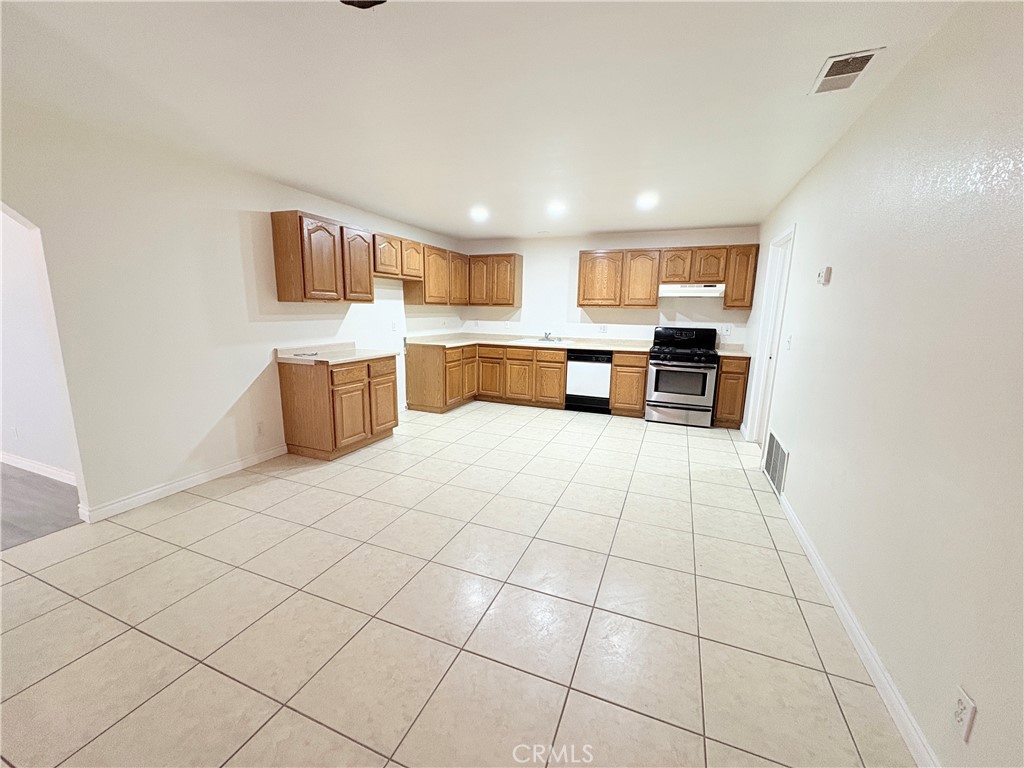 14027 Navajo Road Apple Valley, CA 92307 - Photo 4 of 25 a view of a kitchen with furniture and wooden floor