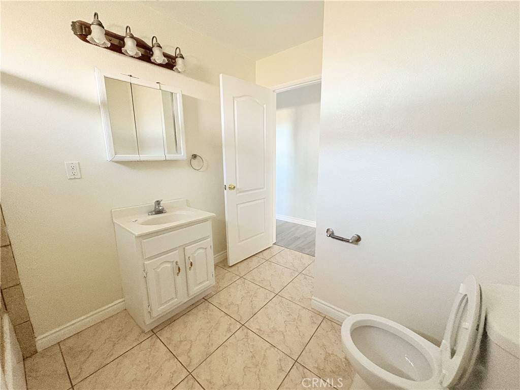 14027 Navajo Road Apple Valley, CA 92307 - Photo 7 of 25 a bathroom with a sink a toilet and shower