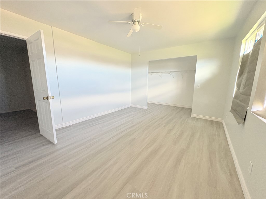 14027 Navajo Road Apple Valley, CA 92307 - Photo 8 of 25 wooden floor in an empty room with a window