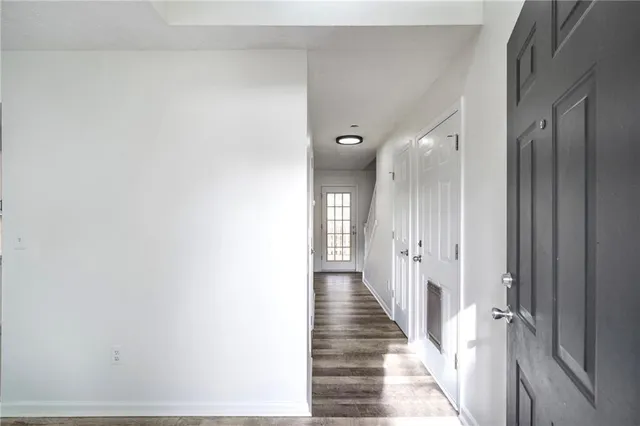 a view of a hallway with wooden floor