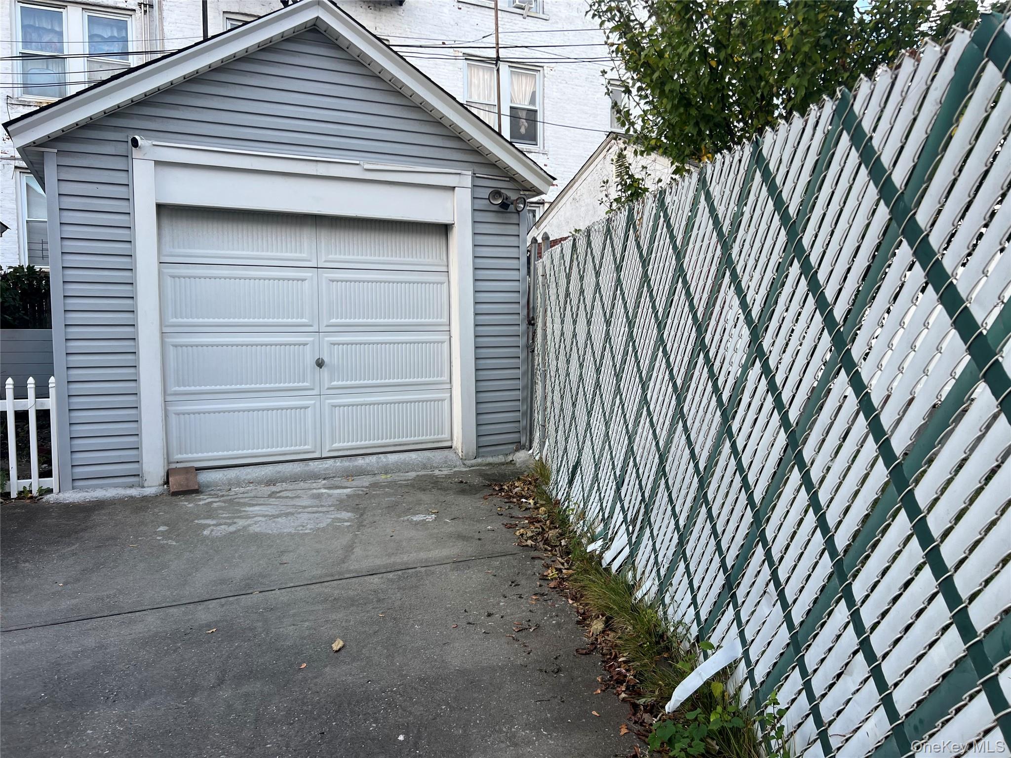 151-08 33rd Road Queens, NY 11354 - Photo 14 of 22 Detached garage with concrete driveway